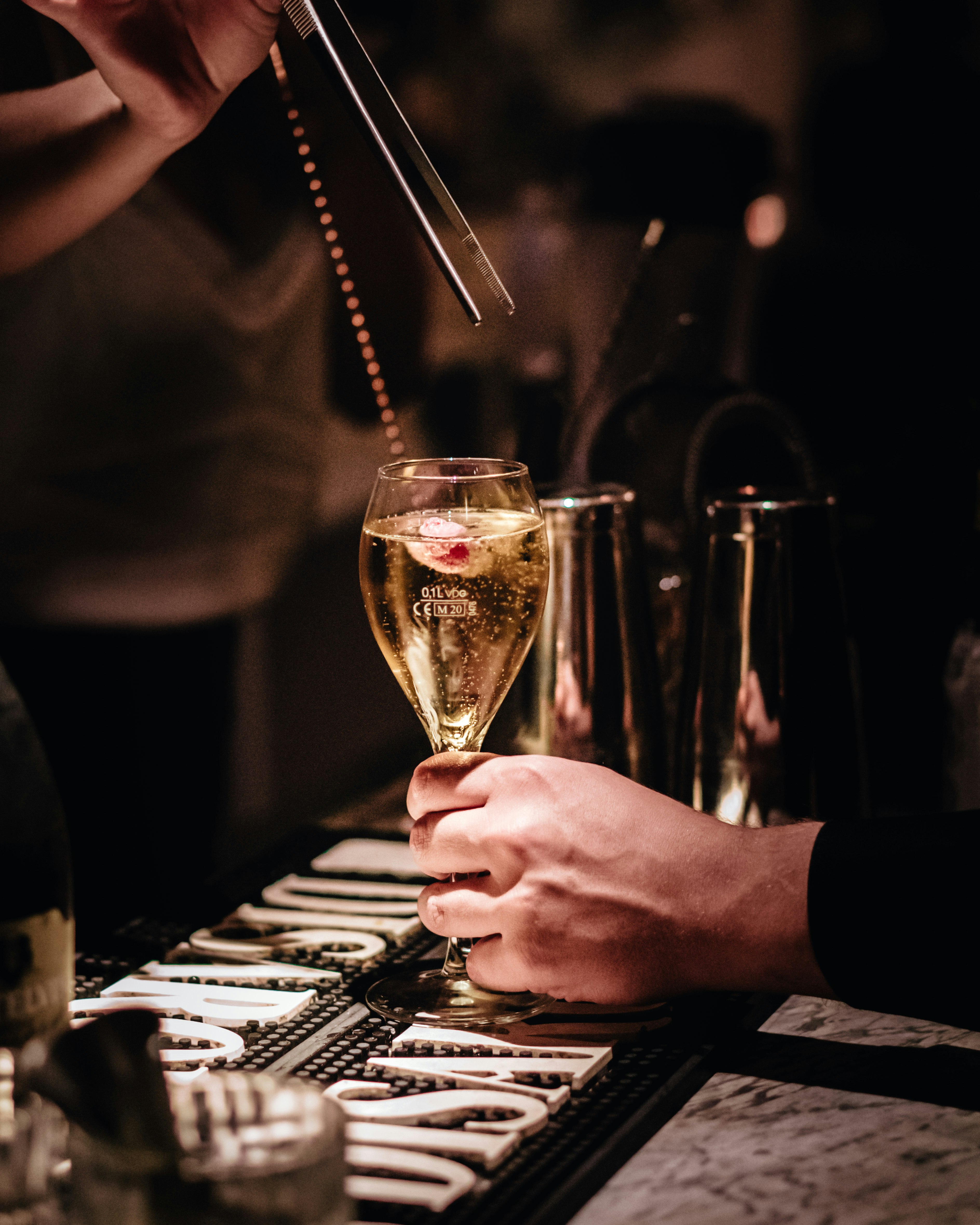 person holding clear wine glass